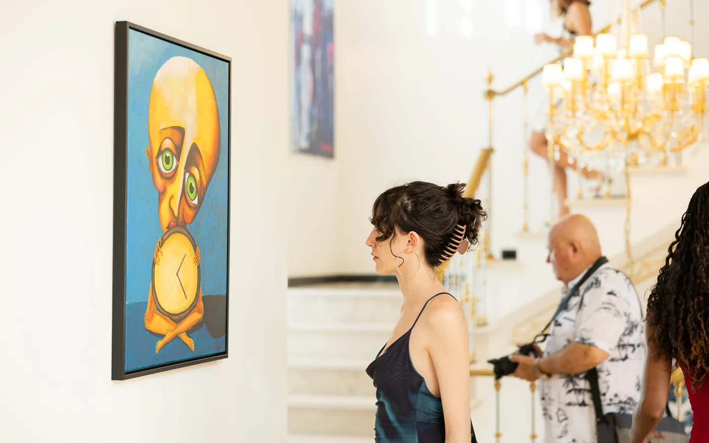 TFAG Art House El Martinete gallery interior, visitor viewing a large colorful portrait
